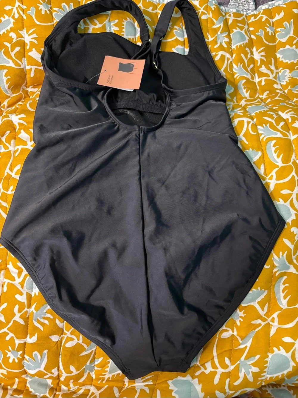 Black swimsuit with gold accessories